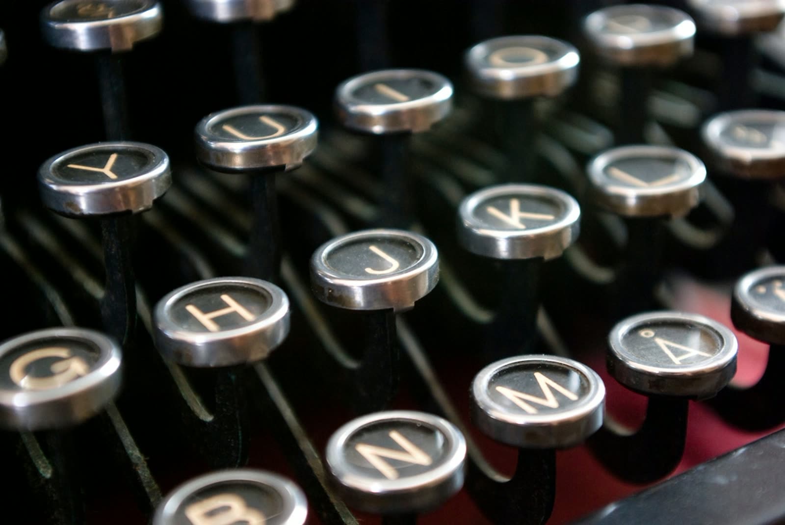 A close-up of the round metal keys of a vintage manual typewriter.